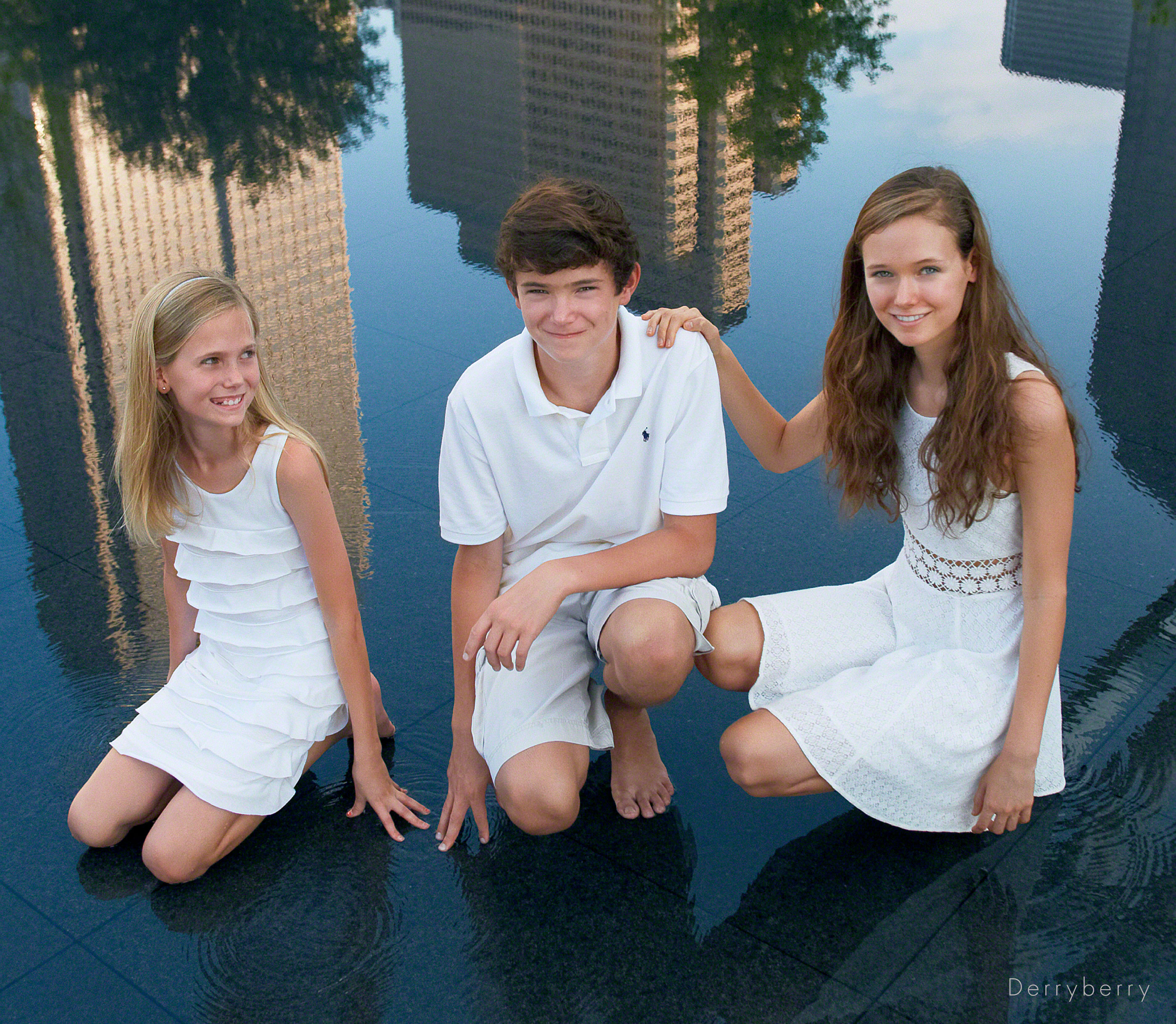 Color location portrait of the Downey children in the water in downtown Dallas, Texas by photographer John Derryberry Photography