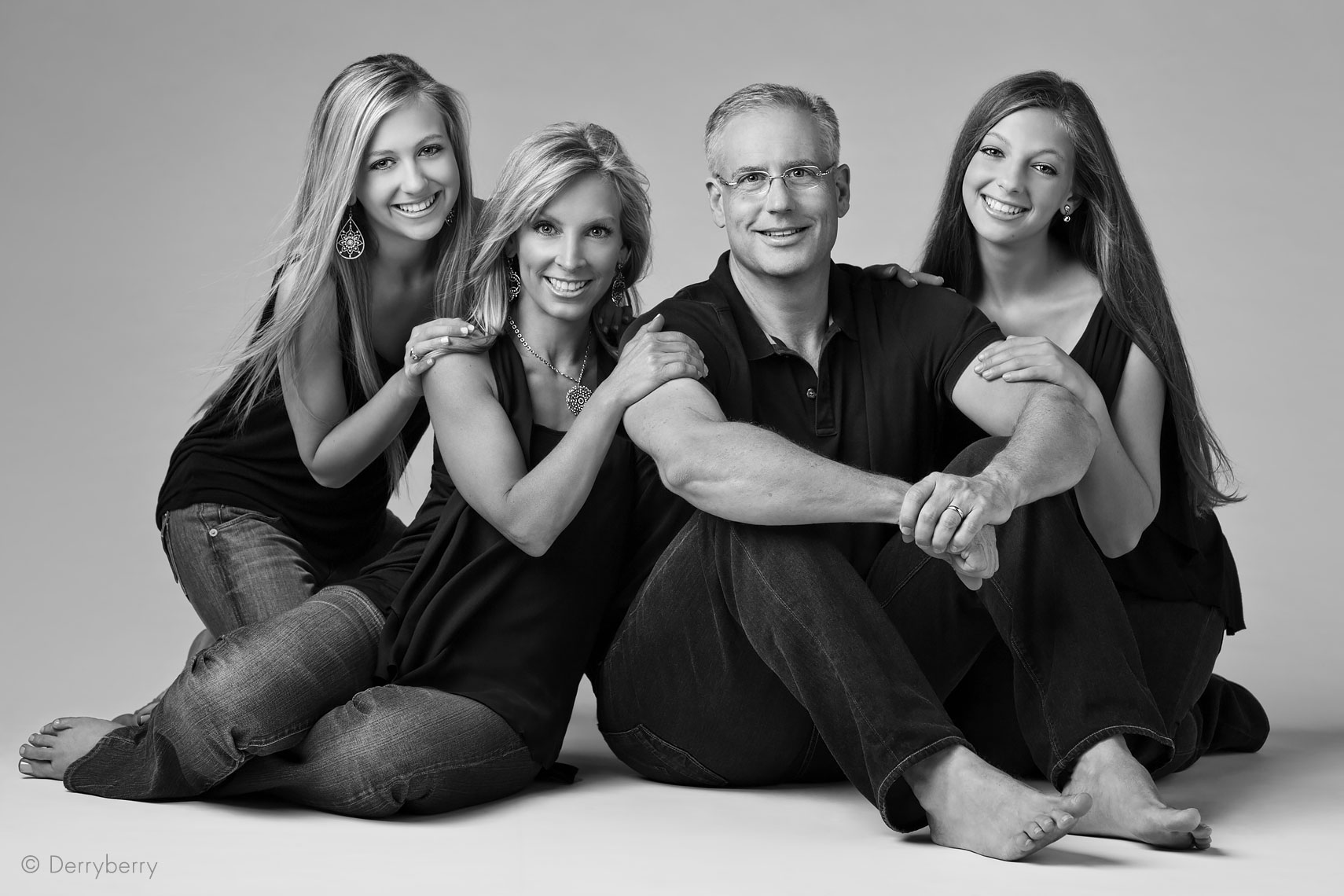 Black and white portrait of the Baron family in the studio  in Dallas, Texas by photographer John Derryberry Photography