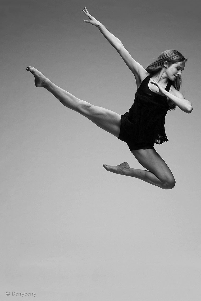 Black and white dance portrait of senior dancer Caroline Magee jumping in the air, from Highland Park, Texas in the studio  in Dallas, Texas by photographer John Derryberry Photography