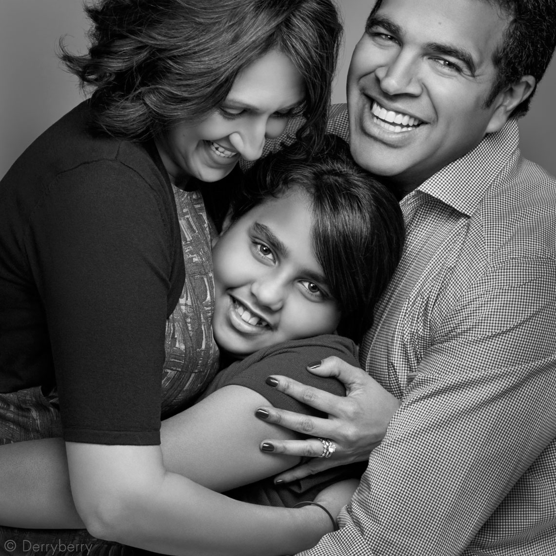 Black and white  group portrait of the Sharma family in the studio in Dallas, Texas by John Derryberry Photography
