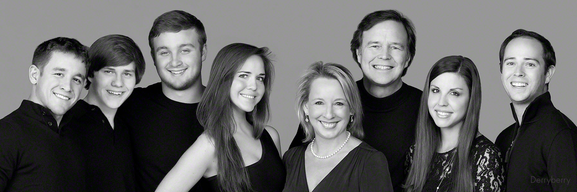 Black and white blended family portrait in the studio  in Dallas, Texas by photographer John Derryberry Photography