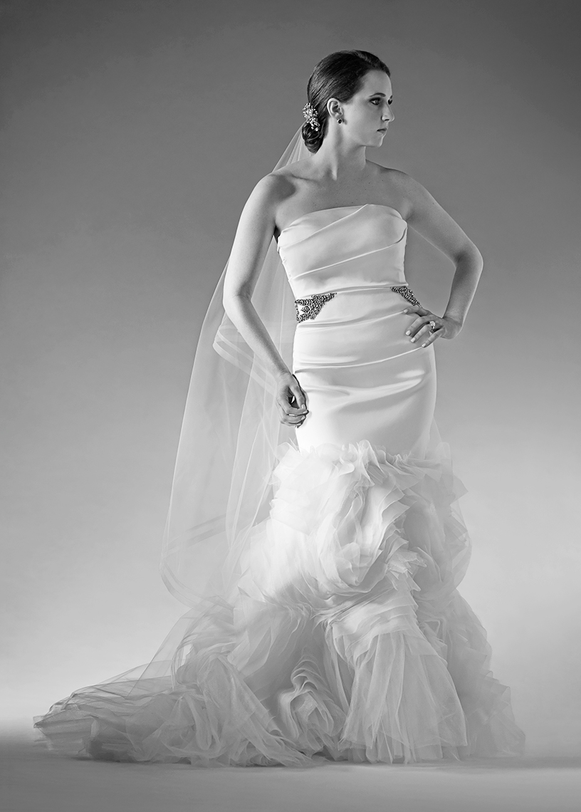 Standing sculptural black and white bridal portrait of a bride in the studio.