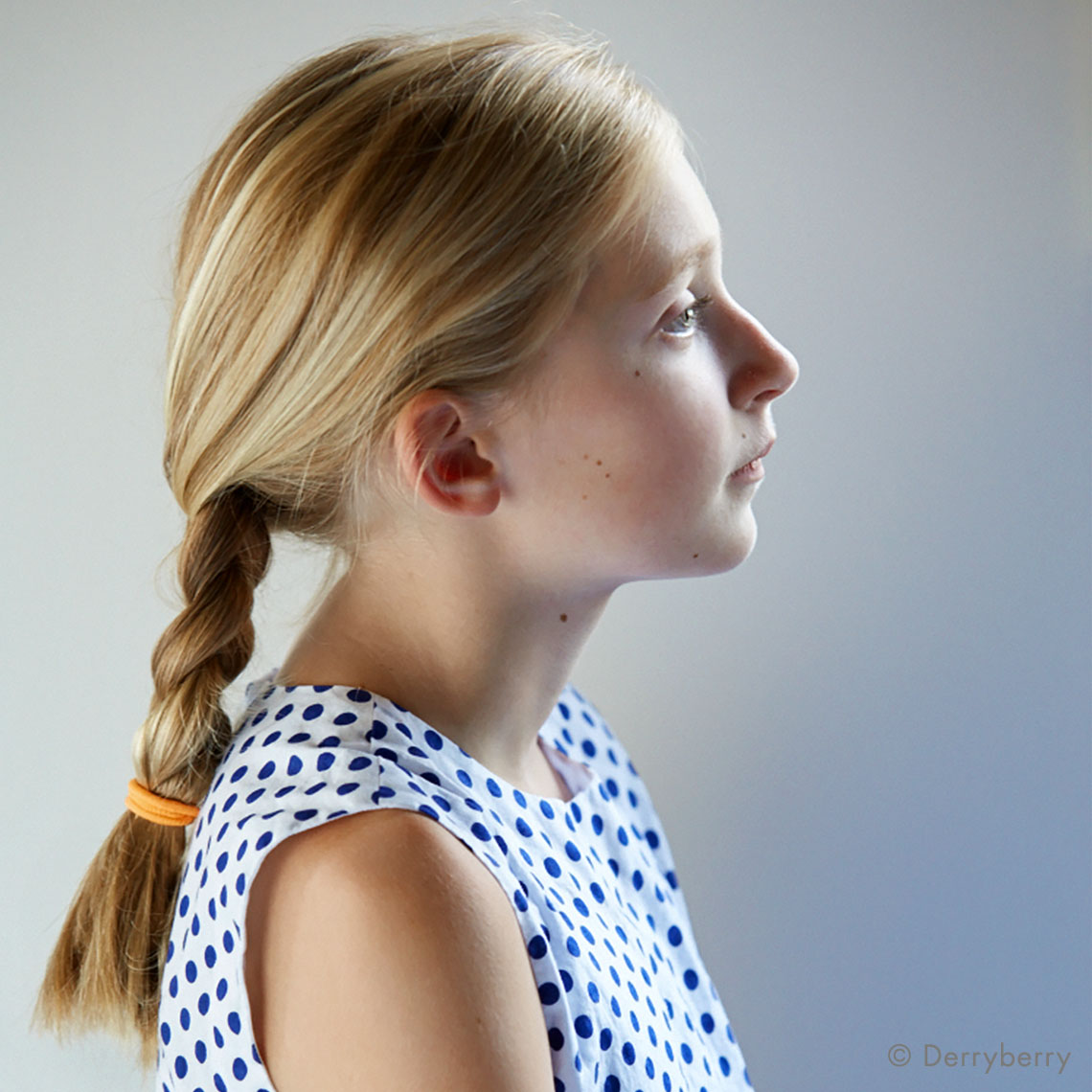 profile portrait of a girl with a pony tail braid