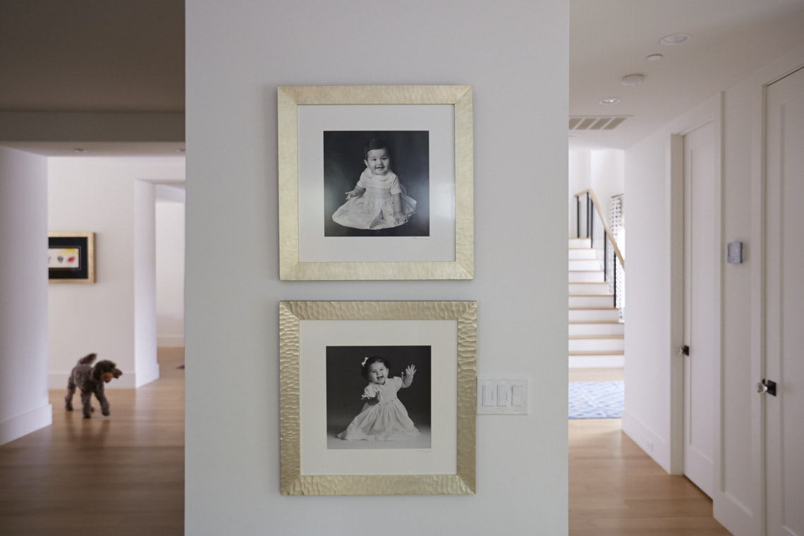 Carmen and Andy Young  home gallery wall collection of  portraits hung between two doors by Dallas, Texas photographer John Derryberry Photography