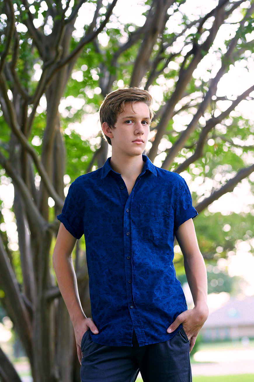 Portrait of teen boy Levis on location with trees in Dallas, Texas by photographer John Derryberry Photography 