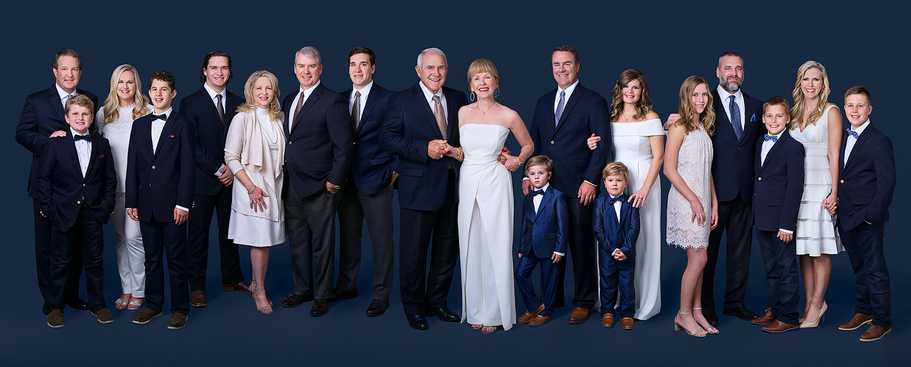 Extended family portrait of the Gilbert grand parents with their children and grand children in the studio in Dallas, Texas by photographer John Derryberry Photography