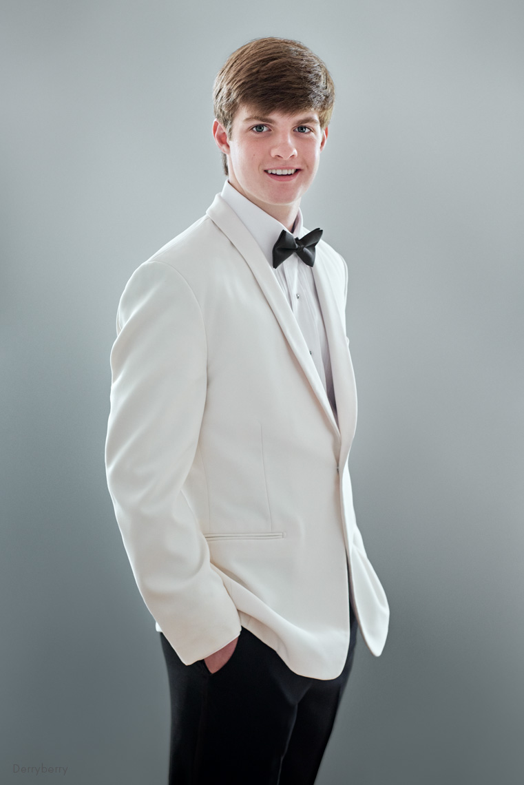 Senior portrait of Andrew Charlton in a tuxedo in the studio by John Derryberry Photography
