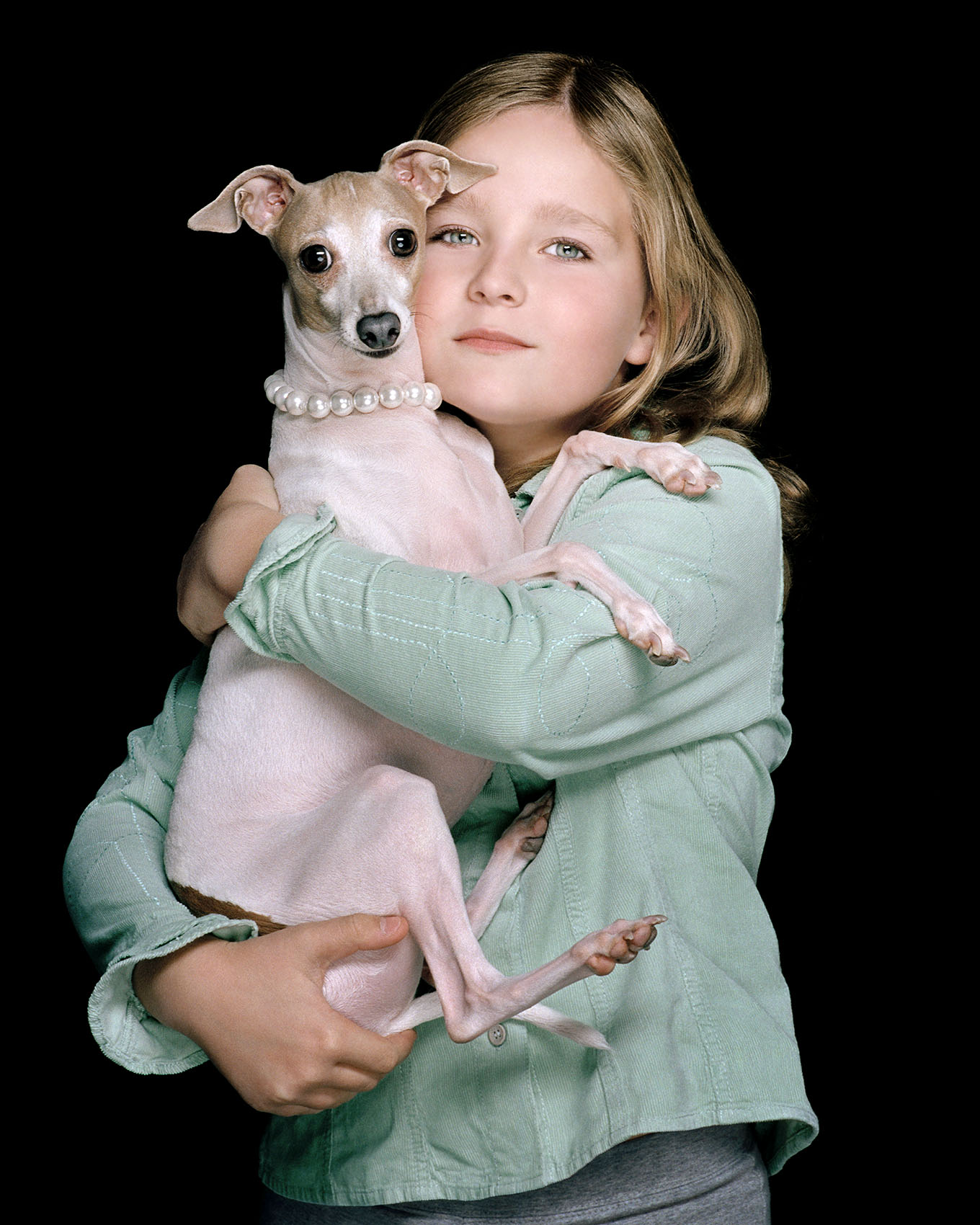 Color portrait of Emma Boulle with her Italian greyhound in a pearl collar in the studio  in Dallas, Texas by photographer John Derryberry Photography
