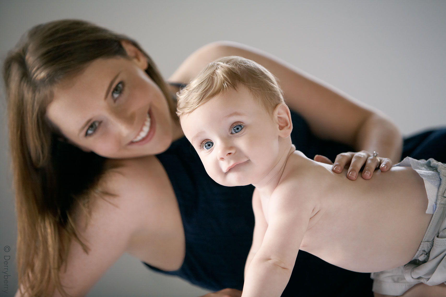 Portrait of mother and baby boy in the studio in color