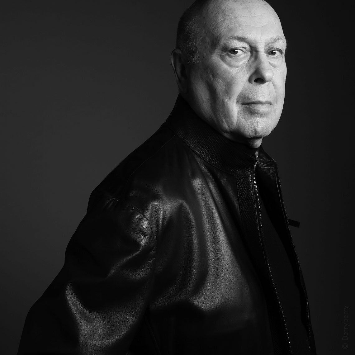 Black and white portrait of businessman Jim Ellis in a leather jacket in the studio  in Dallas, Texas by photographer John Derryberry Photography
