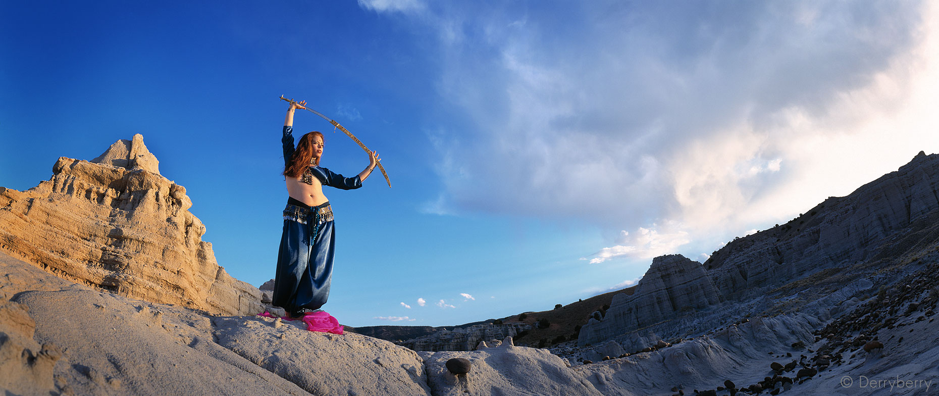 Panoramic portrait of Myra Krien dancing with a sword at the White Place in New Mexico in Dallas, Texas by photographer John Derryberry Photography