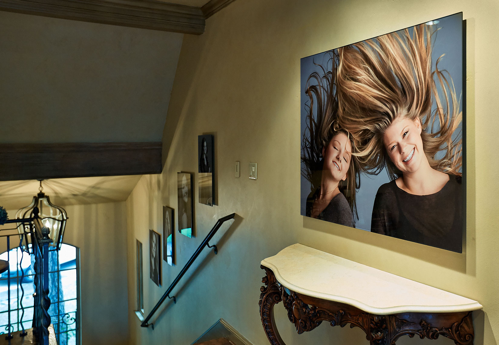 Home stairs gallery wall collection of large portraits by Dallas, Texas photographer John Derryberry Photography