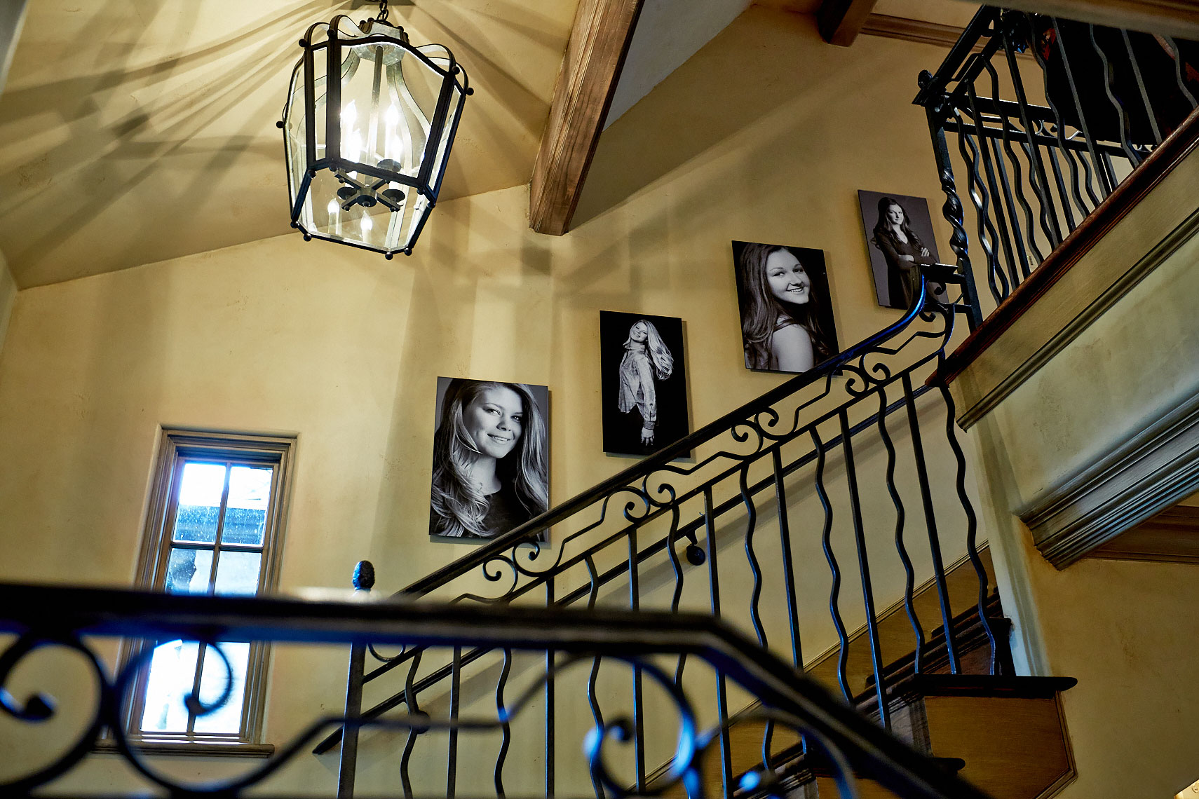 Home stairs gallery wall collection of portraits by Dallas, Texas photographer John Derryberry Photography